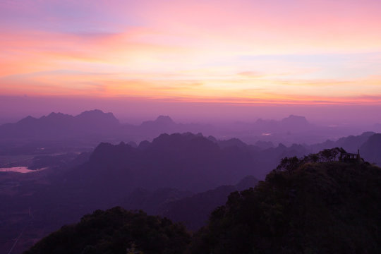 Sunset at Hpa-An mountains in Myanmar. Beautiful pinkish landscape with misty valleys.