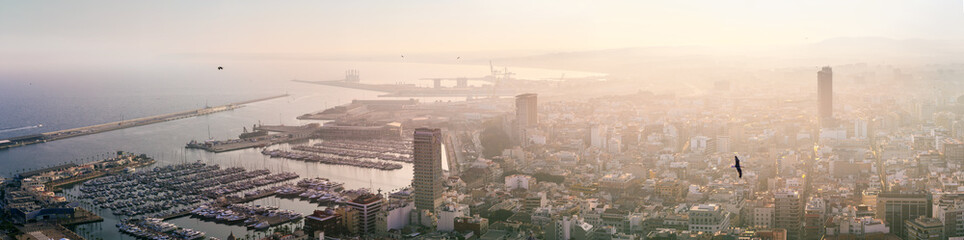 Breathtaking aerial panoramic view from Mount Benacantil of beautiful sunset over old part city of Alicante. Costa Blanca. Alicante, province of Valencia, Spain.