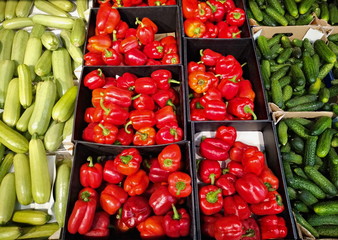 red pepper, cucumbers, zucchini in a box on the shelves in the supermarket