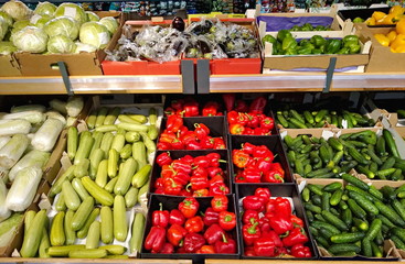 vegetables in a box on shelves in a supermarket