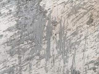 Abstract and texture of embossing on the cement surface caused by flicking the plastering trowel.