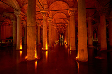Stone columns backlit in red in the Basilica Cisterna in Istanbul, Turkey.