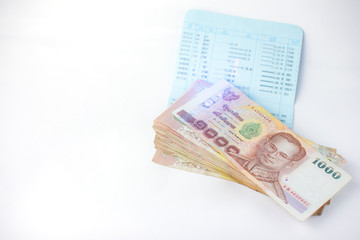 Thai money banknotes 1000 baht and book bank on white background, business investment concept .Selective focus.