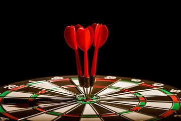 Fototapeta premium Red three darts arrows in the target center