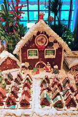 A Christmas gingerbread cookie house decorated with colorful candy for the holidays