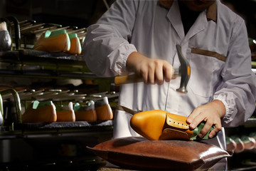 Expert Italian craftsman at work in a luxury shoe factory