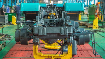 Conveyor assembly stage the body of tractor at factory timelapse