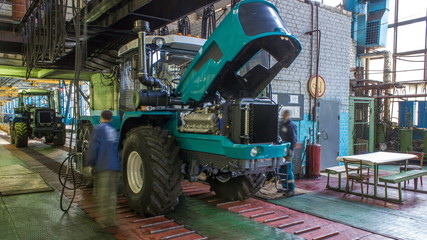 Fototapeta na wymiar Conveyor assembly stage the body of tractor at factory timelapse