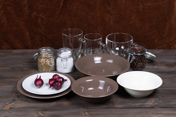 Ingredients and kitchen utensils for cooking various side dishes and porridge on a wooden table