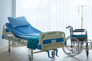Patient room in hospital.  Bed and medical equipped with wheelchair for comfortable patient. ...