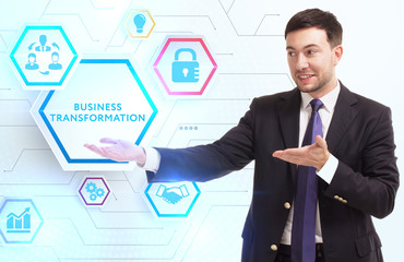 Business, Technology, Internet and network concept. Young businessman working on a virtual screen of the future and sees the inscription: Business transformation