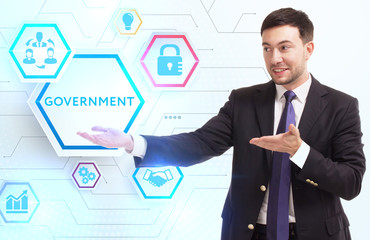 Business, Technology, Internet and network concept. Young businessman working on a virtual screen of the future and sees the inscription: Government