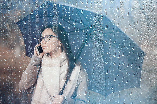 Woman Talking On The Phone In The Fall Rain / Autumn Weather Message About The Rain, A Model With An Umbrella