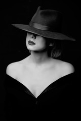 Style woman in hat. Portrait of black and white color style