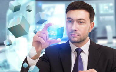 Business, Technology, Internet and network concept. Young businessman working on a virtual screen of the future and sees the inscription: taxes reform