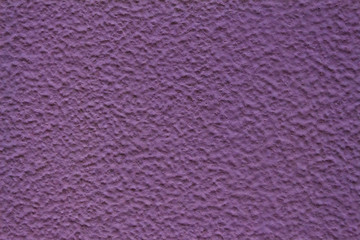 Purple wall with a small size texture. dried paint with small irregularities. corrugated wall surface.