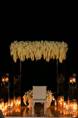 Wedding amazing altar with many burning candes at night.