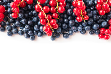Mix berries on a white background. Ripe blueberries and red currants on white background. Top view. Fruits with copy space for text. Mix berries and fruits. Background berries and fruits. 