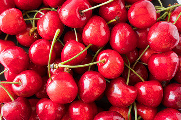 Fresh red cherries. Texture cherries fruits close up. Cherry fruit. Cherries with copy space for text. Top view. Background of cherries.