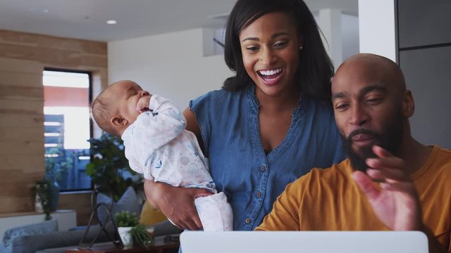 African American family at home with father using laptop