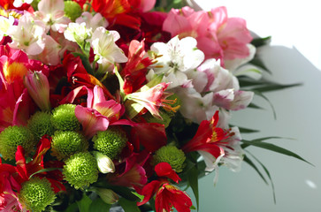 Blurred floral background. A beautiful bouquet of different spring bright flowers. The rays of the sun fall on a bouquet of flowers. Cropped shot, horizontal, closeup. Natural beauty concept.