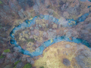 Curves of the Rozhaika river in the forest. Drone Aerial top down view beautiful autumn landscape.