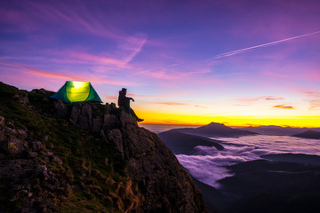 Naklejka premium I wake up nearby in the tent on a beautiful sunset in Peñas de Aya and a sea of clouds below. Basque Country