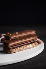 Chocolate layered cake with milk chocolate, praline, ganache, almond dacquoise