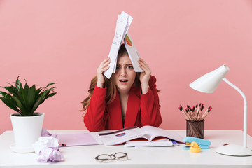 Negative young woman holding documents.
