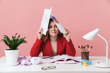 Negative young woman holding documents.