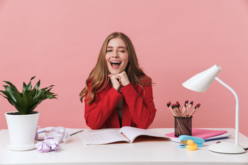 Positive young woman sit at the table