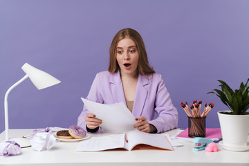 Surprised young woman holding documents.
