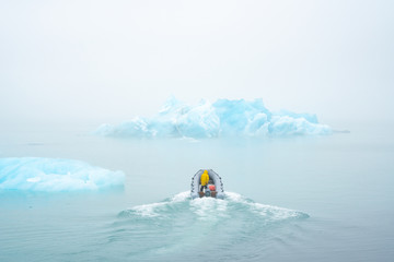 scientists on the boat study the melting of icebergs due to global warming