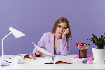 Sad young woman holding documents.