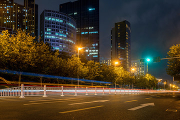 Fototapeta na wymiar Office buildings and highways at night in the financial center, qingdao, China