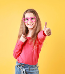 Child,young girl thumb finger up positive emotions concept.