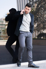 Young happy and seductive successful businessman talking on mobile phone