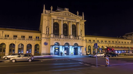 Obraz premium People on the Tomislav Square in front of Main Railway Station night timelapse , main hub of Croatian Railways network. ZAGREB, CROATIA