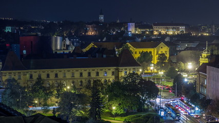 Naklejka premium Panorama of the city center night timelapse shoot from top of the skyscraper with a view to the intersection in front of national theater and museum in Zagreb, Croatia.