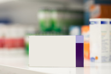 Decanter packs of pills on the background of a shelf with pills