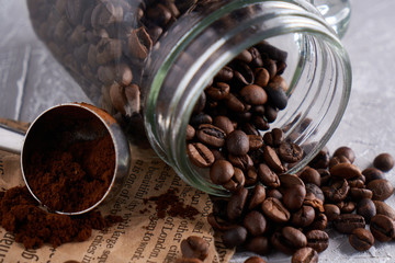 Coffee beans in a glass jar on a gray table