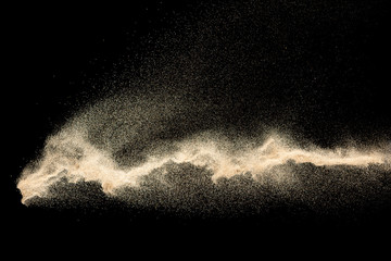 Dry river sand explosion.Brown color sand splash against black background. - obrazy, fototapety, plakaty