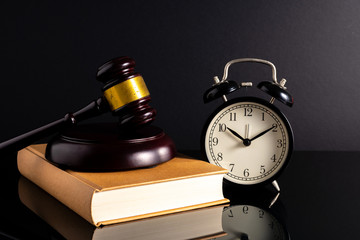 Gavel hammer and book with low light view. Educational concept.