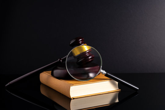Gavel hammer and book with low light view. Educational concept.