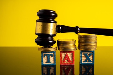 Stacking coins and gavel hammer with financial concept.