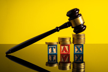 Stacking coins and gavel hammer with financial concept.