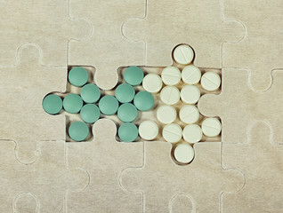 Pills are in place of the missing puzzle pieces.