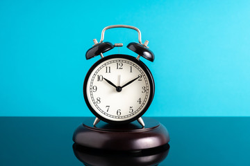 Clock with blue background with puntuality concept.