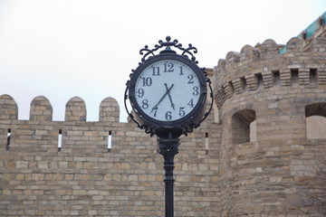 Fototapeta na wymiar Historic street clock on Central Street . Clock on a pillar in a small town .