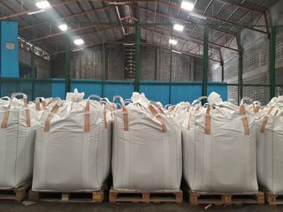 Chemical fertilizer Urea Stock pile jumbo-bag in warehouse waiting for shipment Put on wooden pallets.